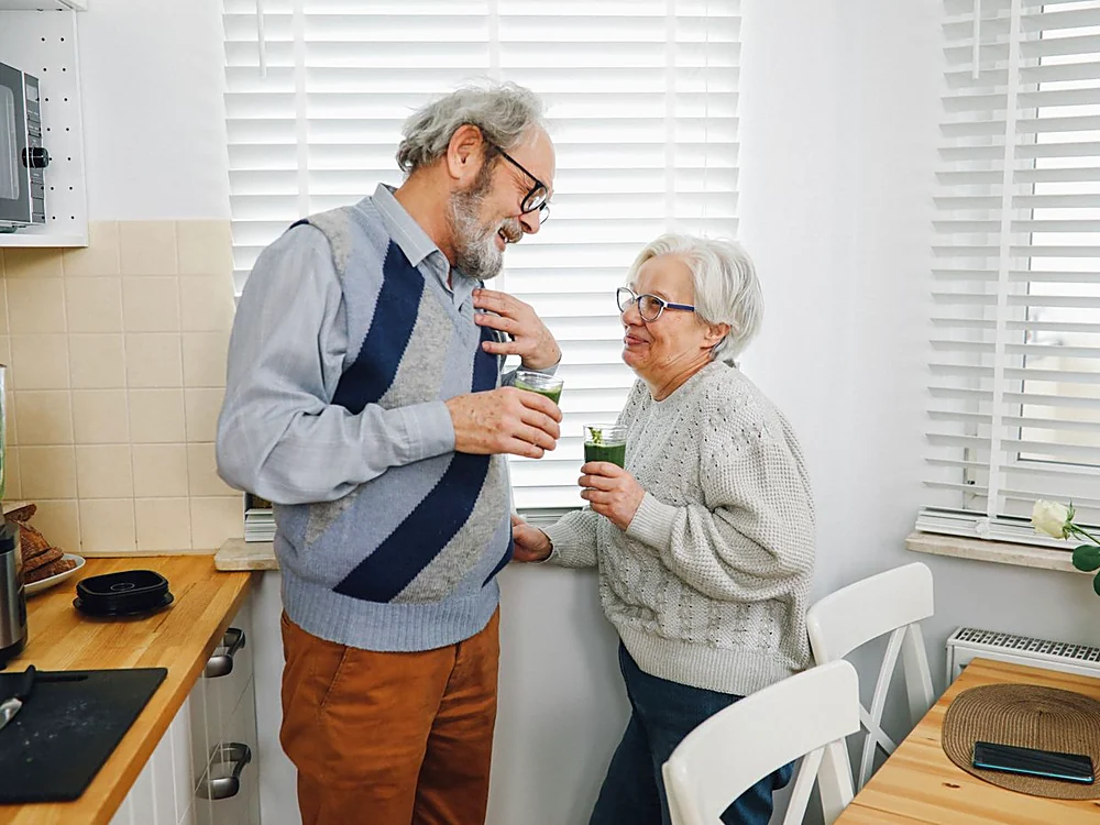A couple in their sixties at home choosing a Welavie supplement together