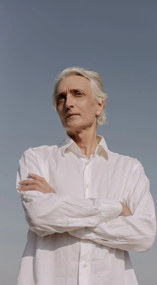 A man in his sixties with his arms folded — weak flow and night-time trips, the prostate concern ProstaVive targets